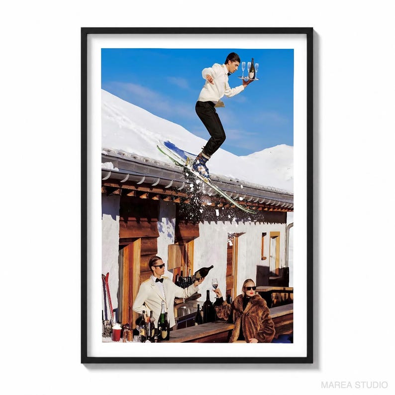 May include: A framed art print featuring a person in a white jacket and black pants skiing off a snowy roof while holding a tray with a bottle and glasses. Below, a person in a white tuxedo pours a drink while another in a fur coat holds a glass.