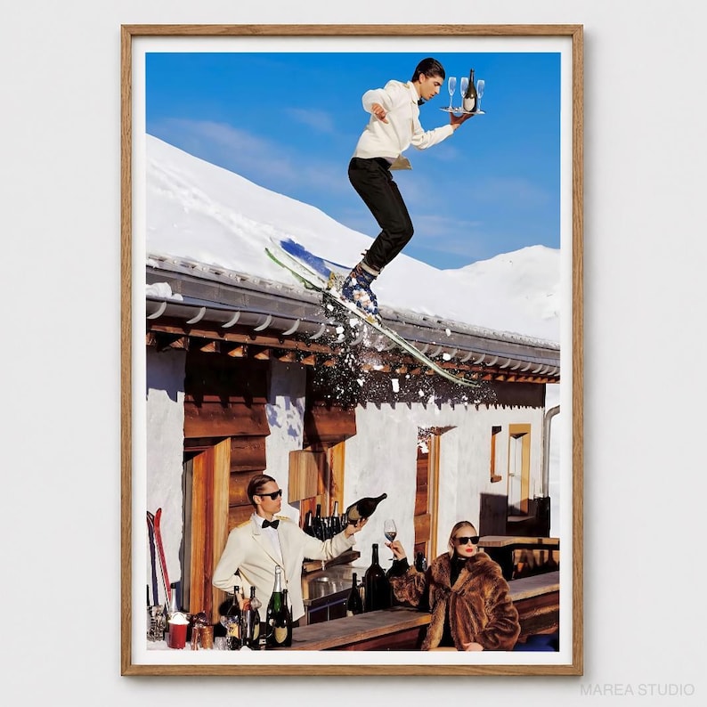 May include: A framed art print depicting a person in a white hoodie and black pants skiing off a snowy roof while holding a tray with a bottle and glasses. Below, a person in a white jacket pours wine while another in a fur coat sits nearby.