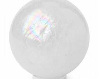 May include: A clear, spherical quartz crystal ball resting on a small, transparent circular stand. The stone features internal fractures and inclusions that create a distinct, multi-colored iridescent rainbow reflection on its upper surface.