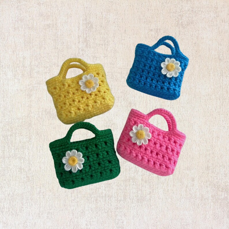 May include: Four small crocheted bags with daisy flower embellishments. The bags are in yellow, blue, pink, and green.