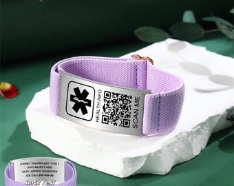 May include: A lavender medical ID bracelet with a metal plate displaying a medical symbol, QR code, and the text "HEALTH INFO" and "SCAN ME". The back of the bracelet has text that reads "KIDNEY TRANSPLANT TYPE 1" and other medical information.