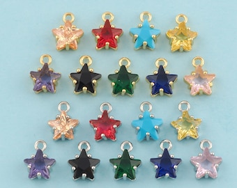 May include: Assortment of 15 gold star-shaped charms with colorful crystal accents. Each charm features a different color crystal, including red, blue, green, turquoise, and pink.