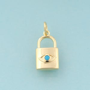 May include: A gold padlock charm with a blue evil eye design. The charm is a popular symbol of protection and good luck.