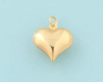 May include: A gold heart-shaped pendant charm. The charm is smooth and shiny.