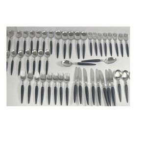 Könnte beinhalten: Ein Set aus Edelstahl-Besteck mit schwarzen Griffen. Das Set umfasst Löffel, Gabeln und Messer, die auf einer weißen Oberfläche angeordnet sind. Das Besteck hat ein modernes Design und eignet sich für formelle Anlässe.