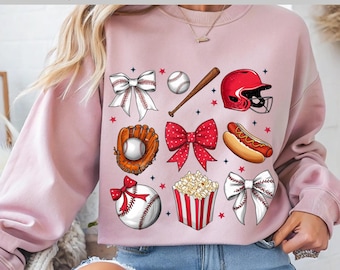 May include: Pink sweatshirt with baseball-themed graphics, including a baseball, bat, glove, helmet, popcorn, and hot dog. The text "Ready to press DTF Transfer" is at the top. The design features red and white accents.