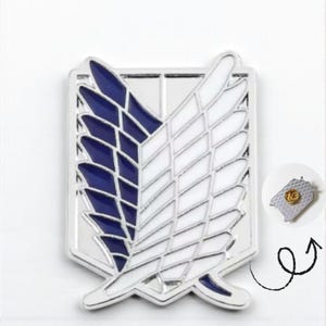 May include: A silver-colored pin featuring a stylized wing design with blue and white sections. The pin has a detailed, geometric pattern and a shiny finish. A smaller, circular pin with a gold emblem is also shown.