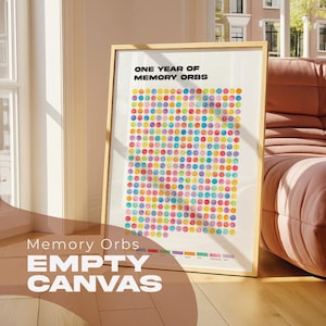 May include: A framed print with the text "One Year of Memory Orbs" and a grid of multi-coloured dots. The frame is light wood. The words "Memory Orbs EMPTY CANVAS" are at the bottom of the print.