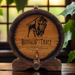 May include: A wooden barrel-shaped decanter with a black buffalo silhouette and the text "Buffalo Trace Kentucky Straight Bourbon Whiskey".