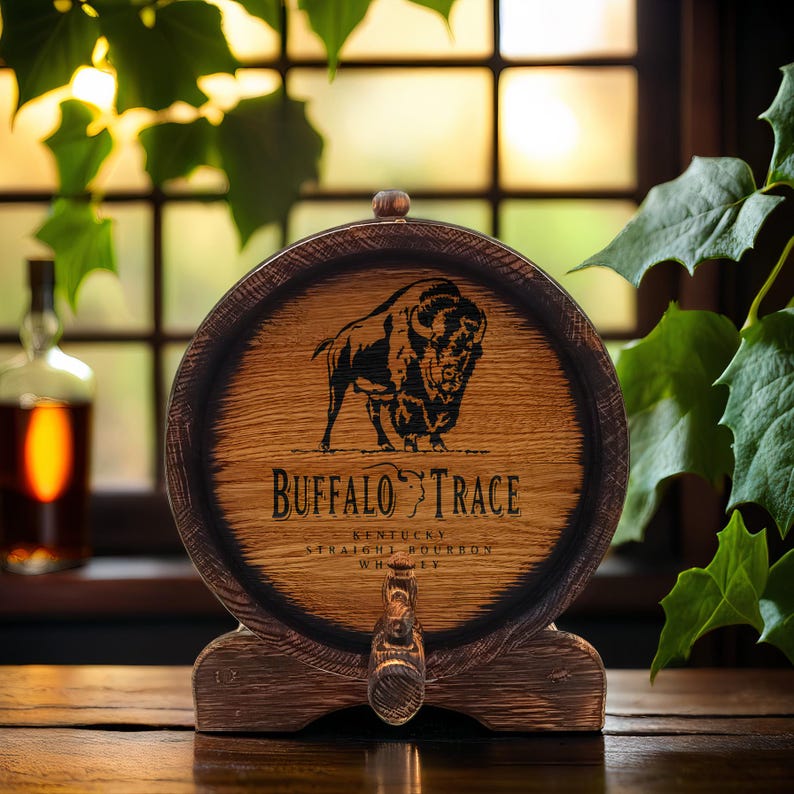 May include: A wooden barrel-shaped decanter with a black buffalo silhouette and the text "Buffalo Trace Kentucky Straight Bourbon Whiskey".