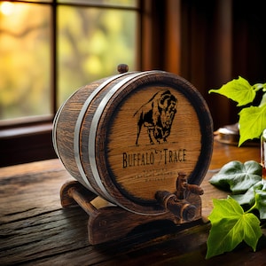 May include: A wooden barrel with a metal band and a spigot. The barrel is decorated with a buffalo silhouette and the text "Buffalo Trace Kentucky Straight Bourbon Whiskey".