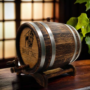 May include: A wooden barrel with metal bands, featuring a buffalo silhouette and the text "Buffalo Trace Kentucky Straight Bourbon Whiskey". The barrel is on a wooden stand with a spigot.