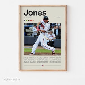 May include: A framed print featuring a baseball player in action, wearing a white and red uniform. The print includes the name "Jones" in bold letters, team colors, and biographical text. The background shows a baseball field.