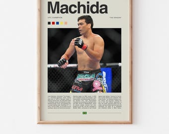 May include: A framed poster featuring mixed martial artist Lyoto Machida. The poster includes the name "Machida" in large black letters, a photo of Machida in the ring, and text detailing his career. The poster has a neutral background.
