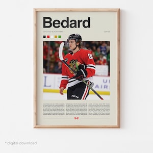 May include: A framed poster featuring the name "Bedard" in bold black letters above a photo of a hockey player in a red and black Chicago Blackhawks jersey. The poster includes text and the Canadian flag.