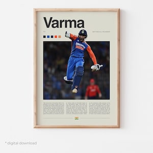 May include: A framed poster featuring a cricket player in action, wearing a blue and orange uniform. The poster has the name "Varma" at the top, with text and the Indian flag at the bottom. The words "Dream India" are visible on the player's shirt.