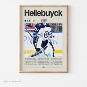 May include: A framed poster with the name "Hellebuyck" in large text, featuring a hockey goalie in a white, blue, and black uniform. The poster includes the number 37, team colours, and player information.