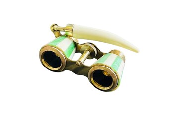 May include: Vintage opera glasses with brass accents and green and white striped barrels. The handle is a curved, off-white color. The binoculars are designed for viewing performances.
