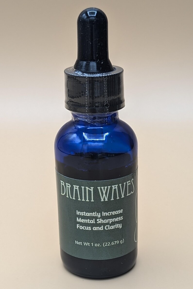 May include: A blue glass bottle with a black dropper top. The bottle has a green label that reads "BRAIN WAVES" and lists the benefits of the product: "Instantly Increase Mental Sharpness Focus and Clarity". The label also states "Net Wt 1 oz. (22.679 g)".