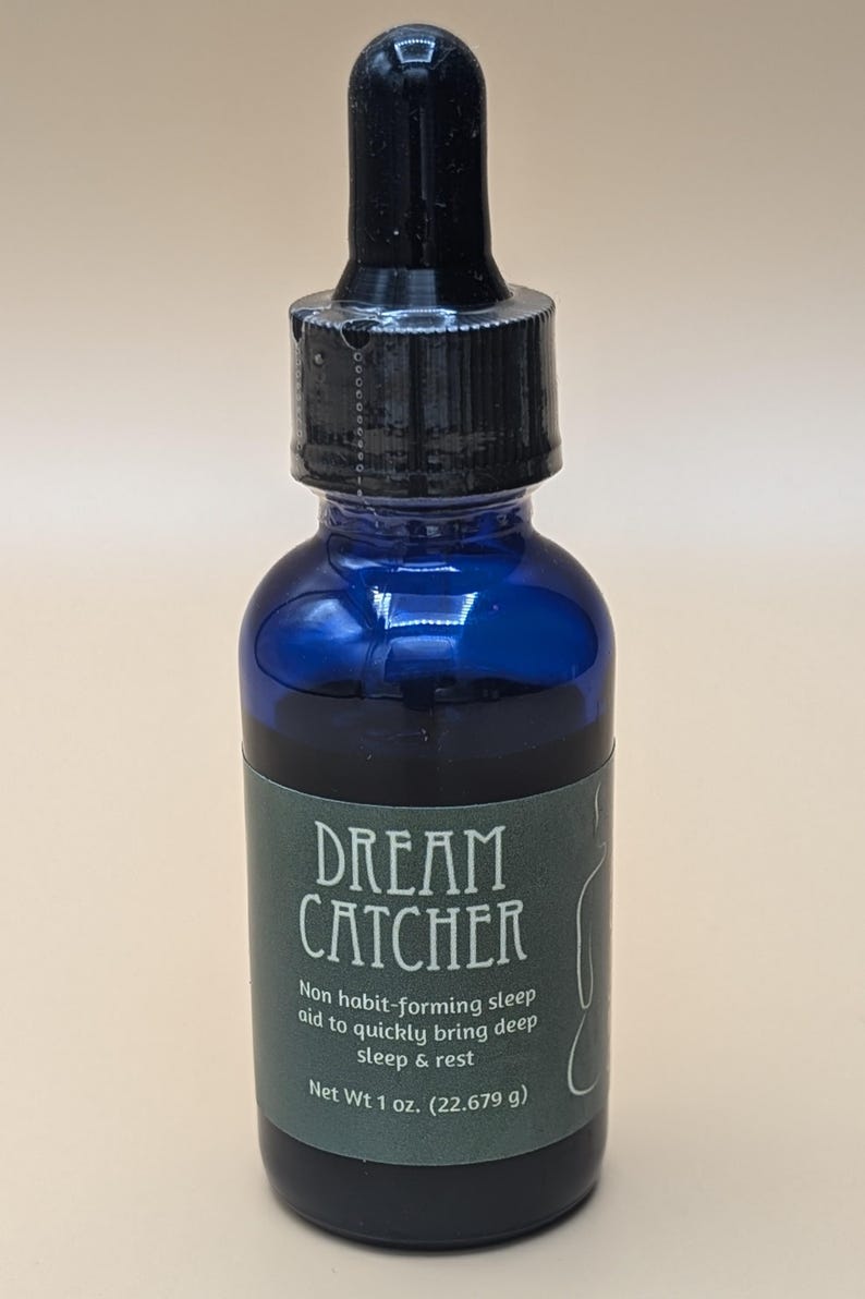 May include: A blue glass bottle with a black dropper top and a green label that reads "DREAM CATCHER" and "Non habit-forming sleep aid to quickly bring deep sleep & rest" and "Net Wt 1 oz. (22.679 g)".