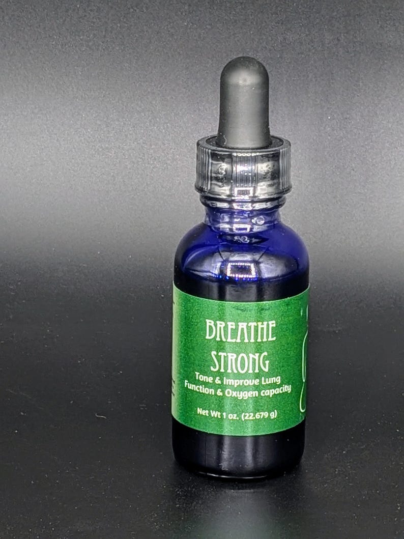 May include: A blue glass bottle with a dropper top and a green label that reads "BREATHE STRONG Tone & Improve Lung Function & Oxygen capacity Net Wt 1 oz. (22.679 g)"