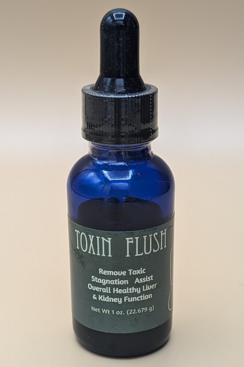 May include: A blue glass bottle with a black dropper top. The label reads "TOXIN FLUSH" and describes the product as a "Remove Toxic Stagnation Assist" that helps with "Overall Healthy Liver & Kidney Function". The bottle contains 1 ounce (22.679 grams) of liquid.