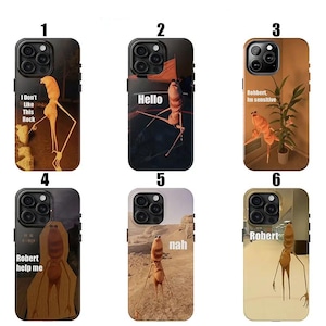 May include: Six phone cases showcasing a tall, orange figure with long limbs. Each case has a unique background and text: "I Don't Like This Rock", "Hello", "Robbert, Im sensitive", "Robert help me", "nah", and "Robert". The cases are designed for a smartphone.