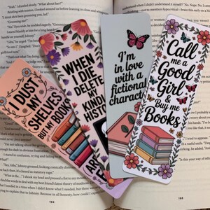 May include: Four colorful bookmarks with floral and butterfly designs. Each bookmark has a unique quote: "I Dust My Shelves But My Books", "When I Die Delete My Kind History", "I'm in love with a fictional character", and "Call me a Good Girl & Buy me Books".
