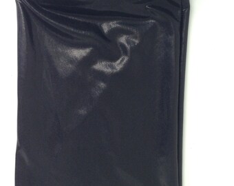 May include: A black drawstring bag made of a shiny, textured material. The bag is rectangular with a gathered top and a black cord for closure. The background is plain white.