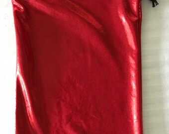 May include: A red drawstring bag made of shiny fabric. The bag is empty and has a black drawstring.