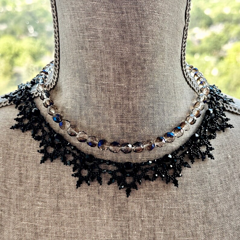 Elaborate handmade beaded necklace by Isabel Design Studio, in shiny black, shown with another necklace (sold separately).