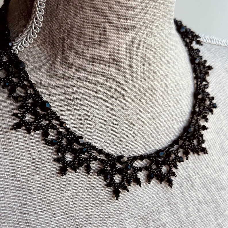 Elaborate handmade beaded necklace by Isabel Design Studio, in shiny black.