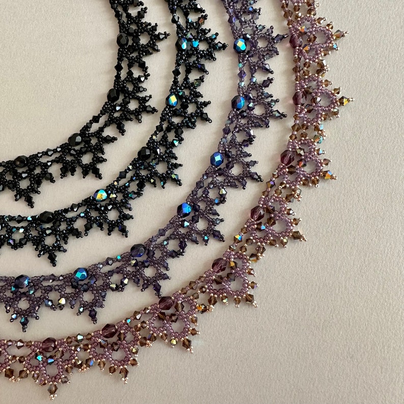 A closeup view of four elaborate handmade beaded necklaces: The Victorian necklace by Isabel Design Studio in Jet black, Iridescent Black, Purple / Blue and Purple / Gold.