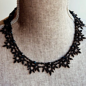Elaborate handmade beaded necklace by Isabel Design Studio, in shiny black.