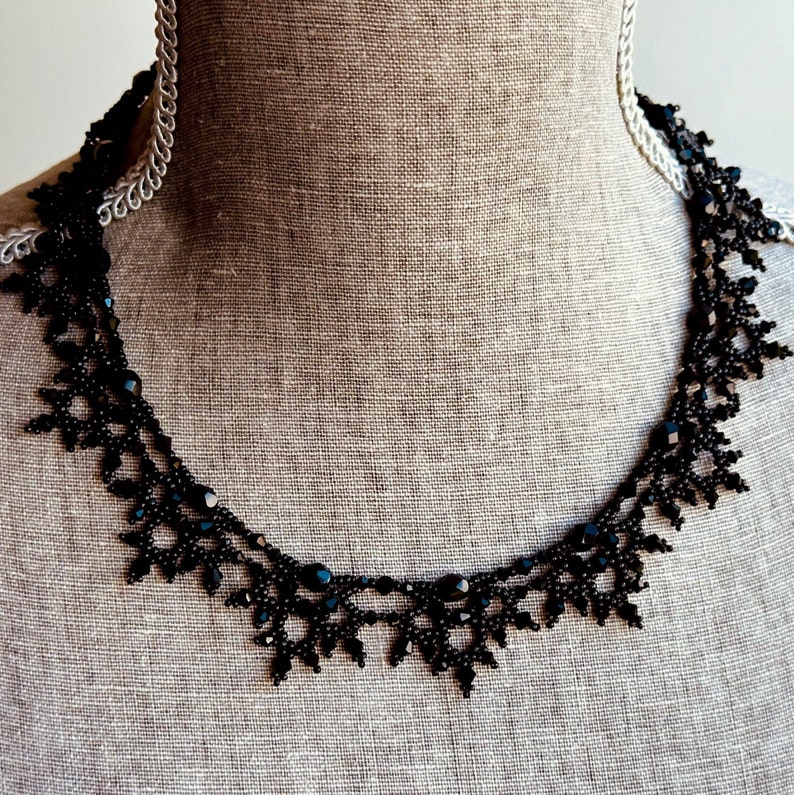 Elaborate handmade beaded necklace by Isabel Design Studio, in shiny black.