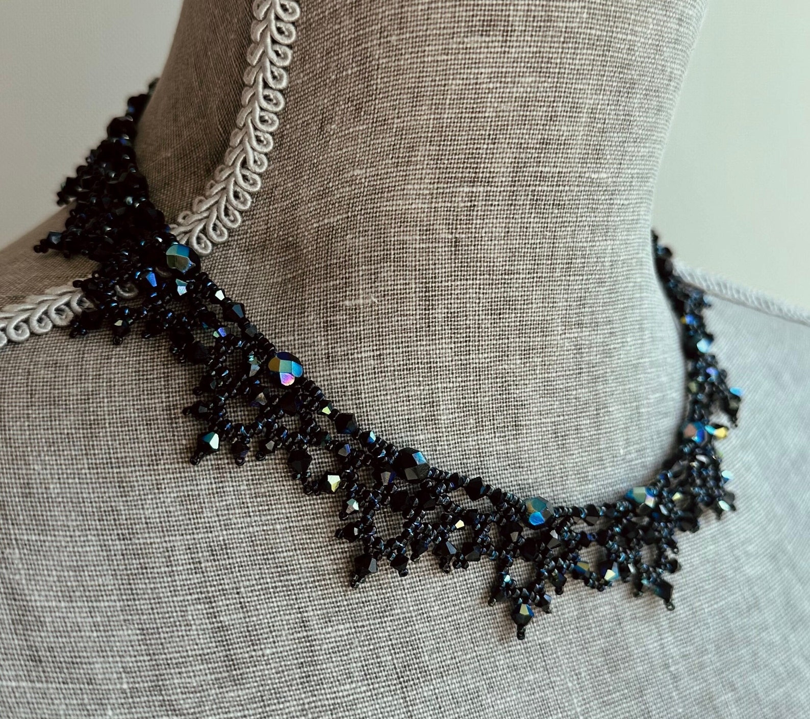 Black Victorian AB crystal necklace with iridescent shimmer and intricate beadwork on linen bust form.