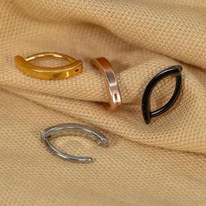 May include: Four hoop earrings in different colors and finishes: gold, rose gold, silver, and black.