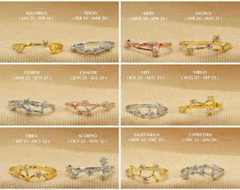 May include: Twelve gold, silver, and rose gold rings with a constellation design and clear cubic zirconia stones. Each ring represents a different zodiac sign with the name and dates of the sign printed above each ring.