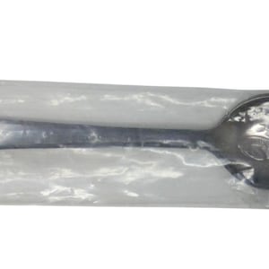 May include: A silver spoon with an elaborate handle and bowl, encased in clear plastic. The handle has a detailed design, suggesting a souvenir or collectible. The spoon is designed for eating. The spoon is sealed in a clear plastic wrapper.