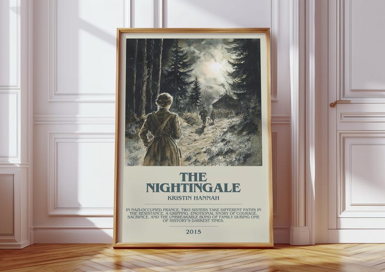 May include: A framed print of "The Nightingale" by Kristin Hannah. The artwork depicts a woman walking on a path towards a cabin in a forest. The title and author's name are displayed below the image, along with a summary and the year 2015.