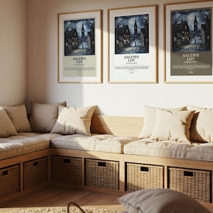 May include: A cozy living space featuring a built-in wooden bench with beige cushions and pillows. Three framed "Salem's Lot" movie posters hang above. Woven baskets are integrated into the bench for storage, and a decorative plant adds warmth.