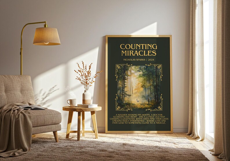 May include: A framed art print with the title "COUNTING MIRACLES" by Nicholas Sparks. The artwork features a forest scene with a deer and text at the bottom. The frame is gold.