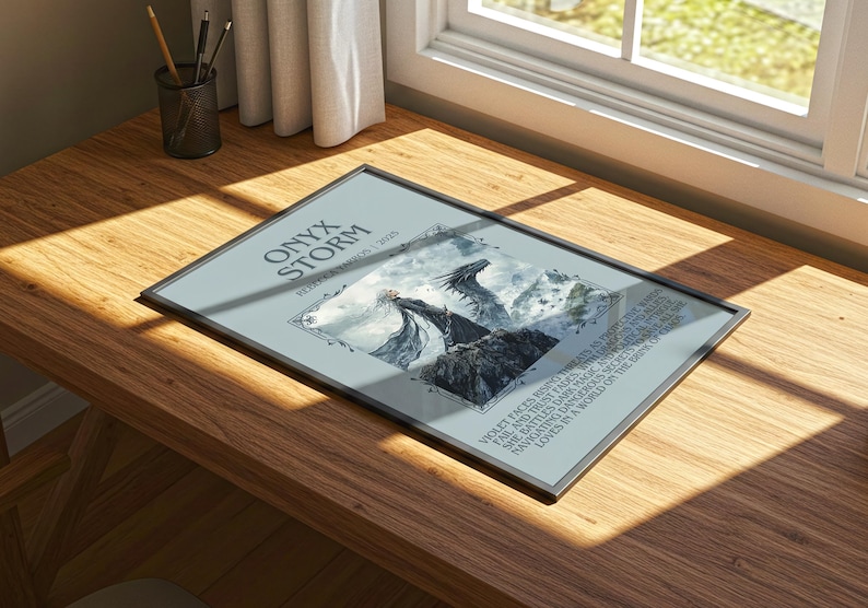 May include: A framed print titled "Onyx Storm" on a wooden desk. The artwork features a fantasy scene with dragons and mountains. The text includes the words "Violet faces rising threats" and "She battles dark magic".