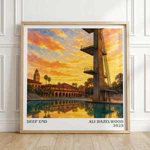 May include: A framed art print titled DEEP END by ALI HAZELWOOD 2025, featuring a tall diving platform beside a swimming pool at sunset. The sky is filled with vibrant orange and yellow clouds, reflecting in the water near a building with arches.