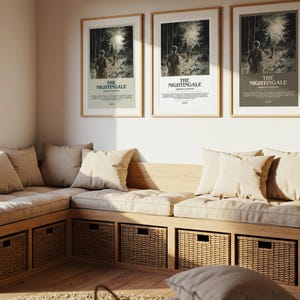 May include: A cozy corner seating area with a wooden frame, beige cushions, and woven storage baskets. Three framed posters with the text "THE NIGHTINGALE" hang above the seating. The room is bathed in natural light.
