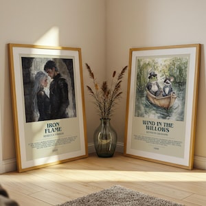 May include: Two framed art prints leaning against a wall. One features a couple with the text "Iron Flame" and the other depicts a frog and a rat in a boat with the text "Wind in the Willows."