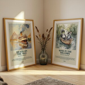 May include: Two framed prints lean against a wall. One shows a ship on a river with "Death on the Nile." The other depicts a frog and a rat in a boat, with the text "Wind in the Willows."