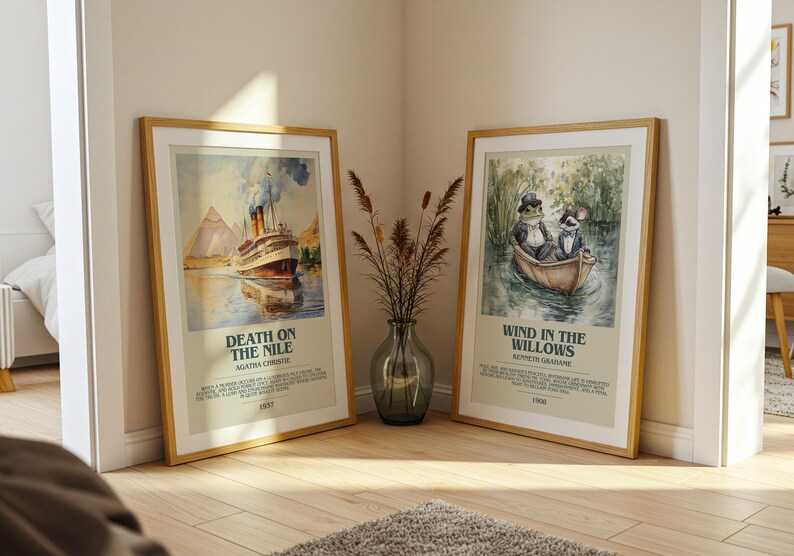 May include: Two framed prints lean against a wall. One shows a ship on a river with "Death on the Nile." The other depicts a frog and a rat in a boat, with the text "Wind in the Willows."