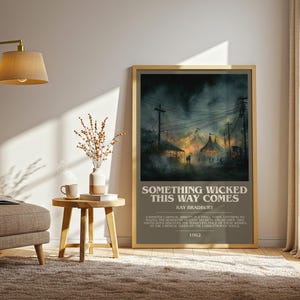 May include: Framed poster with the text "SOMETHING WICKED THIS WAY COMES" by Ray Bradbury. The artwork depicts a dark, atmospheric scene of a carnival with tents and figures, set against a stormy sky. The poster is displayed in a living room setting.