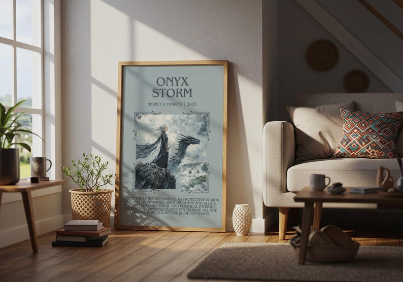 May include: A framed art print titled "ONYX STORM" by Rebecca Yarros, 2015, featuring a fantasy illustration of a figure with a dragon. The artwork is displayed in a living room setting with a window, plants, and a sofa.